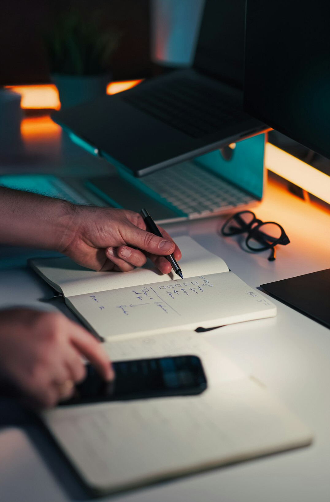 person writing in notebook at night
